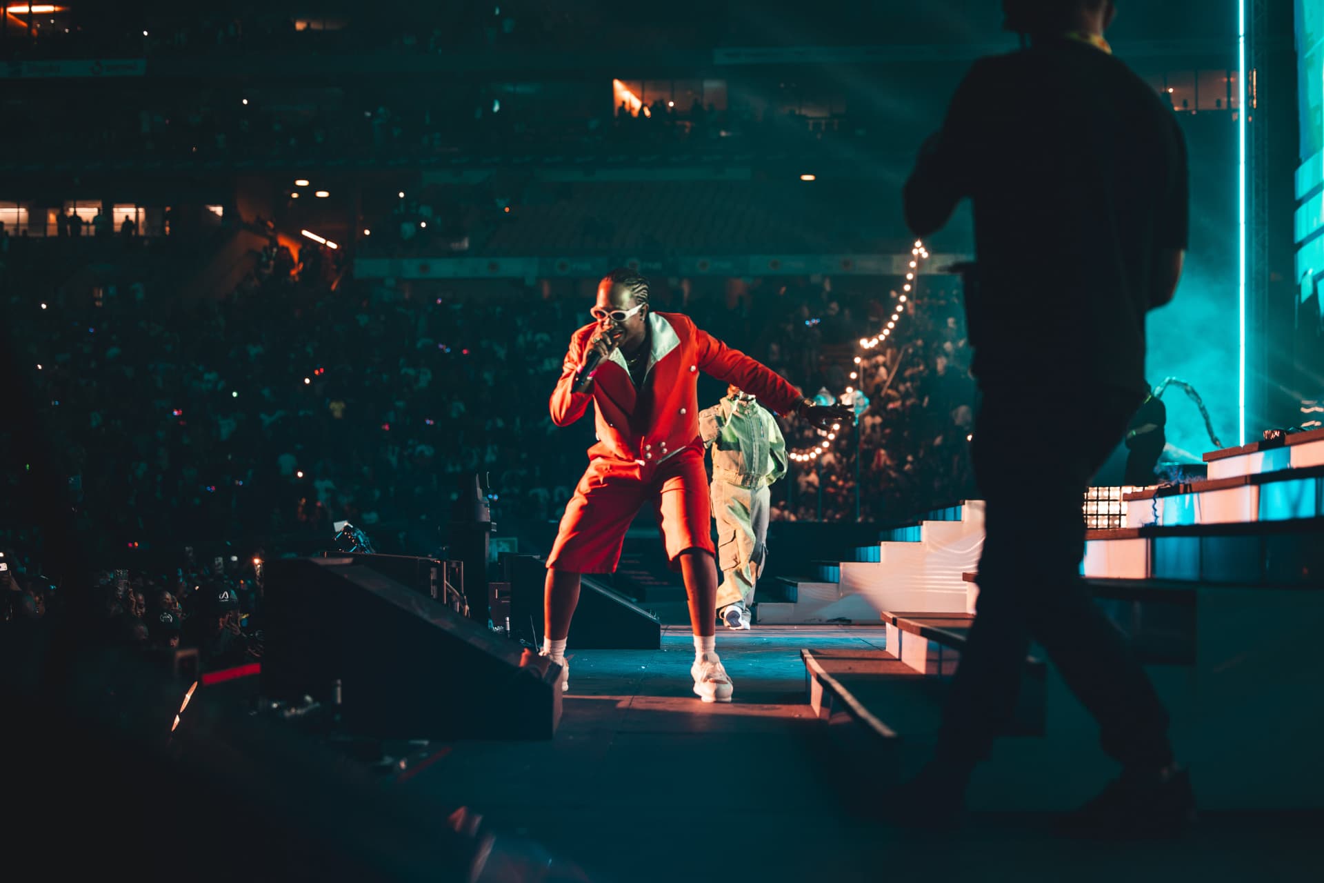Performer in a red suit working the stage runway