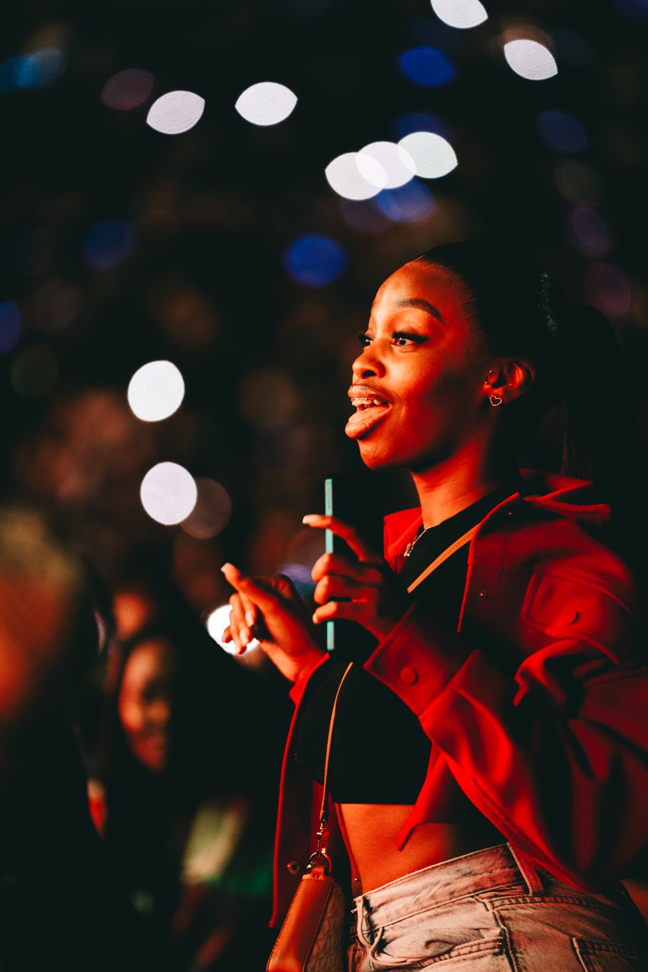Fan laughing in the red stage lights