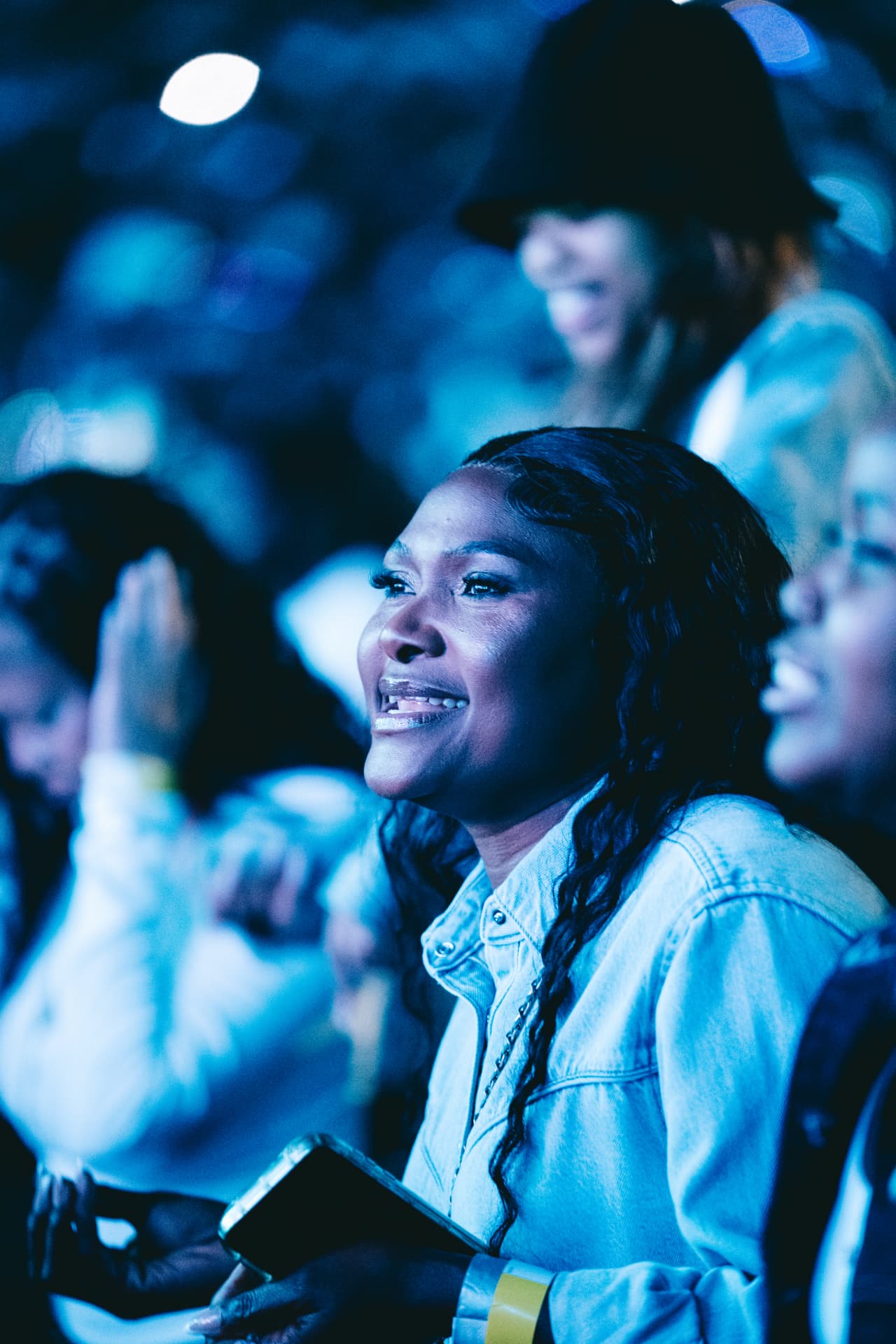 Fan smiling in the blue glow of the stadium