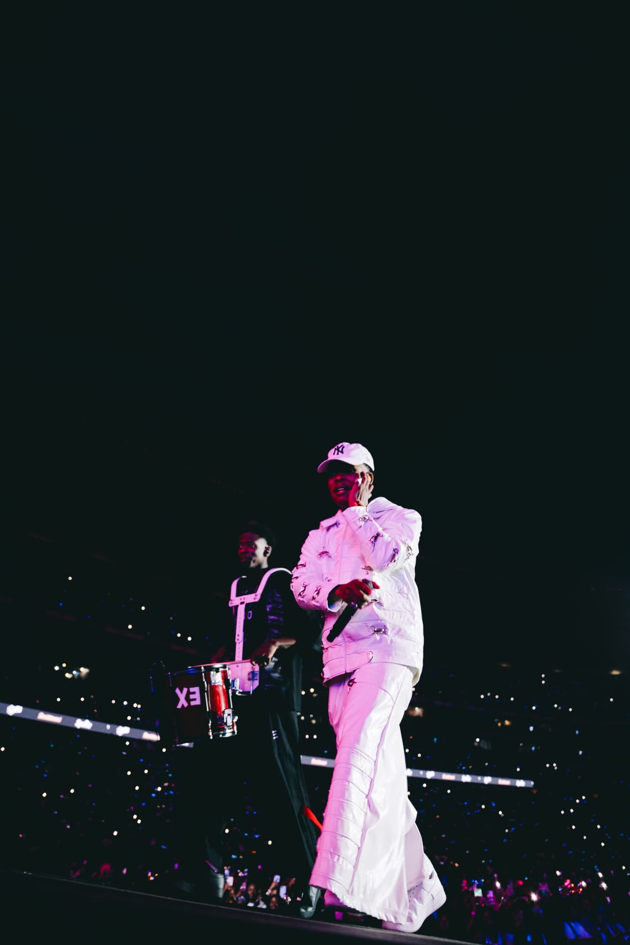 Drummer marching along the stage runway in white