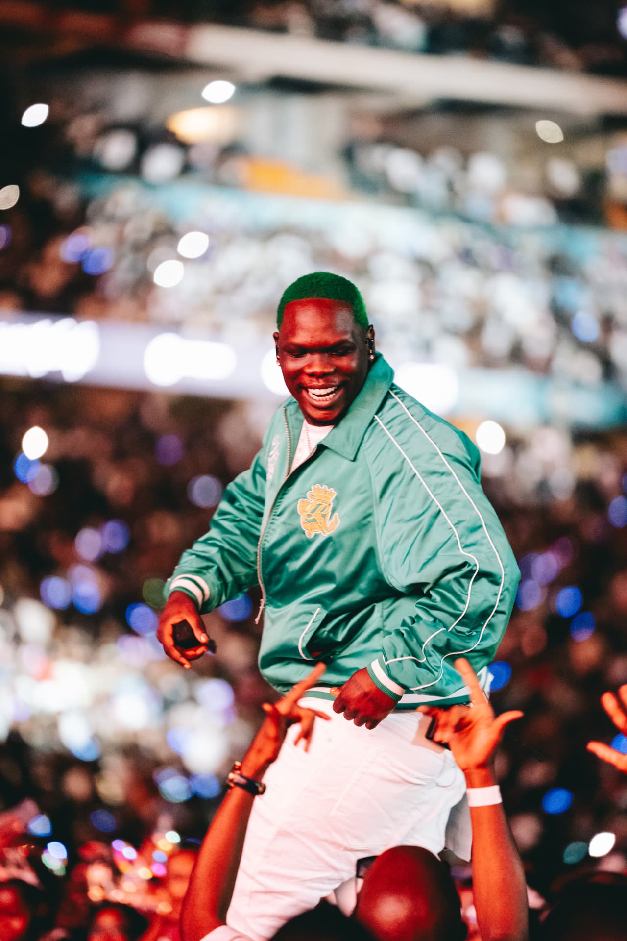 Performer in green connecting with the crowd